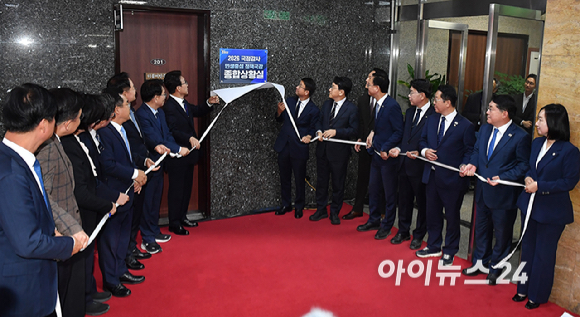 더불어민주당 김민석 당대표와 한병도 원내대표 등 참석자들이 6일 서울 여의도 국회에서 열린 국정감사 종합상황실 현판식에서 현판을 제막하고 있다. [사진=곽영래 기자]