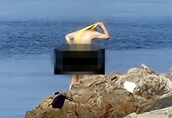 부산 다대포 해수욕장에서 한 남성이 실오라기 하나 걸치지 않은 채 바위 위에서 목욕을 하는 사진이 제보됐다. 사진은 해당 남성. [사진=JTBC '사건반장']