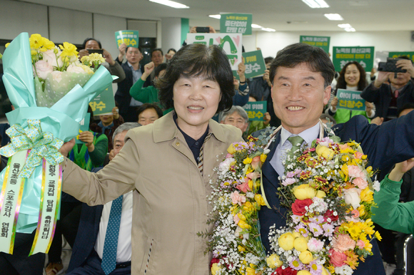 천창수 울산시교육감 후보(오른쪽)가 지난 5일 밤 울산 남구 선거사무소에서 당선이 확실시되자 고(故) 노옥희 전 교육감의 동생 노득현씨와 축하 꽃다발을 받고 기뻐하고 있다. [사진=뉴시스]