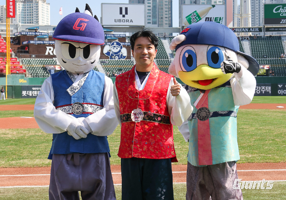 롯데 자이언츠는 이번 추석 연휴 기간 동안 열리는 홈 경기에서 한복 프로모션 행사를 진행한다. 조지훈 구단 응원단장(가운데)이 마스코트인 윈지, 누리와 함께 한복을 착용하고 포즈를 취하고 있다. [사진=롯데 자이언츠]