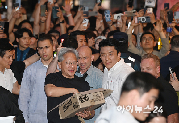 젠슨 황 엔비디아 최고경영자(CEO)가 5일 서울 마포구 서교동의 한 고깃집에서 최태원 SK회장, 구광모 LG회장, 이해진 네이버 의장과 삼겹살 회동에서 시민들에게 HBM 칩을 나눠주고 있다. [사진=곽영래 기자]