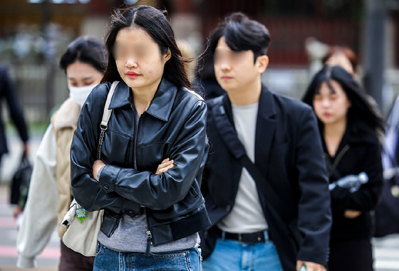 쌀쌀한 날씨를 보인 지난 21일 서울 종로구 광화문네거리에서 몸을 웅크린 시민들이 이동하고 있다. [사진=뉴시스]