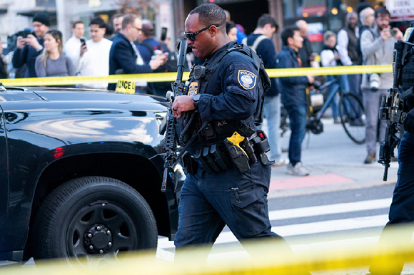 지난 26일(현지시간) 미국 워싱턴 D.C. 백악관 근처에서 주방위군 대원 2명이 총격을 당한 사건이 발생한 가운데, 연방보호국 소속 요원이 통제 구역을 지나가고 있다. [사진=로이터/연합뉴스]