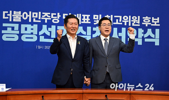 더불어민주당 정청래(왼쪽)·박찬대 당대표 후보가 15일 국회에서 열린 공명선거실천서약식에서 서약서에 서명한 뒤 기념촬영 하고 있다. [사진=곽영래 기자]