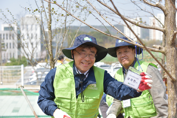 남태헌(가운데) 한국산림복지진흥원장이 9일 산림복지종합교육센터 조성 부지에서 식재한 나무에 이름표를 달고 있다. [사진=한국산림복지진흥원/산림청]