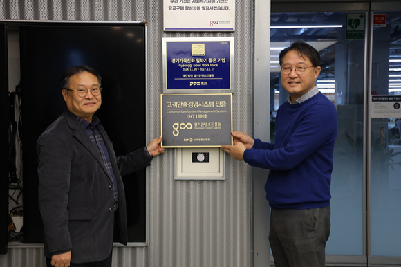 고객만족경영시스템 인증 현판 앞에서 서헌성 경영본부장과 탁용석 원장. [사진=경기콘텐츠진흥원]