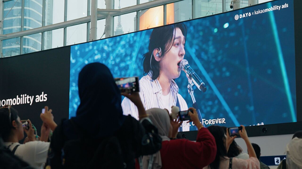 카카오모빌리티가 운영 중인 KTX 서울역 초대형 융복합 안내 전광판 '서울 파노라마'에서 데이식스(DAY6) 10주년 기념 영상이 송출되고 있다. [사진=카카오모빌리티]