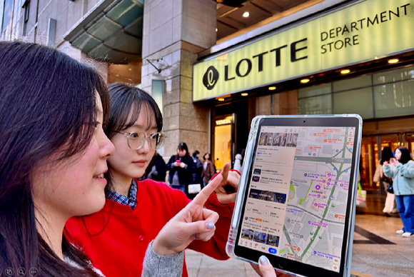서울시 중구 소공동에 위치한 롯데백화점 본점 앞에서 두 모델이 고덕지도 앱을 사용하고 있다 [사진=롯데백화점]