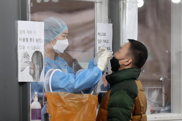 서울 중구 서울역광장 임시선별검사소에서 의료진이 검체를 채취하고 있다. [사진=뉴시스]