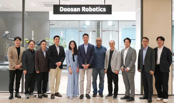 두산로보틱스 김민표 대표(왼쪽 여섯째)와 엔비디아 매디슨 황 수석 이사(왼쪽 다섯째)가 관계자들과 기념사진을 촬영하고 있다. [사진=두산]