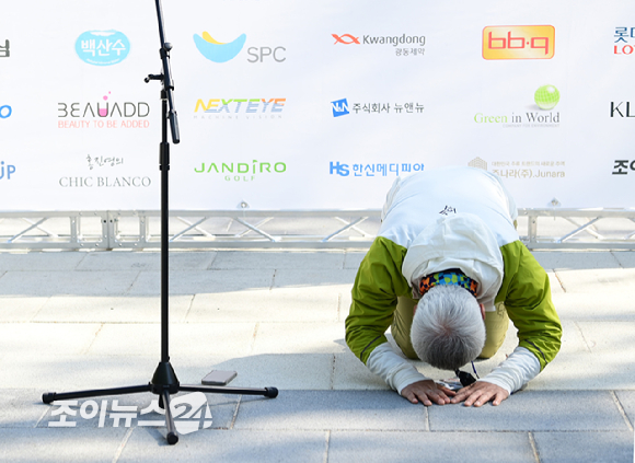 박동석 조이뉴스24 사장이 25일 서울 강북구 우이동 만남의 광장에서 열린 산악인 오은선 대장과 함께하는 '제13회 희망찾기 등산&middot;트레킹 교실' 개막식에서 참석자들을 향해 큰절을 올리고 있다. [사진=정소희 기자]