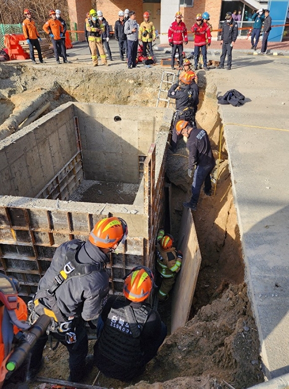 7일 오후 2시11분쯤 청주시 청원구 율량동의 한 중학교 정화조 거푸집 공사 현장에서 근로자 A(54)씨가 흙더미에 파묻혀 소방당국이 구조작업을 벌이고 있다. [사진=청주동부소방서]