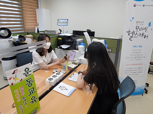 보건소 직원이 모바일 헬스케어 사업을 설명하고 있다. [사진=완주군 ]