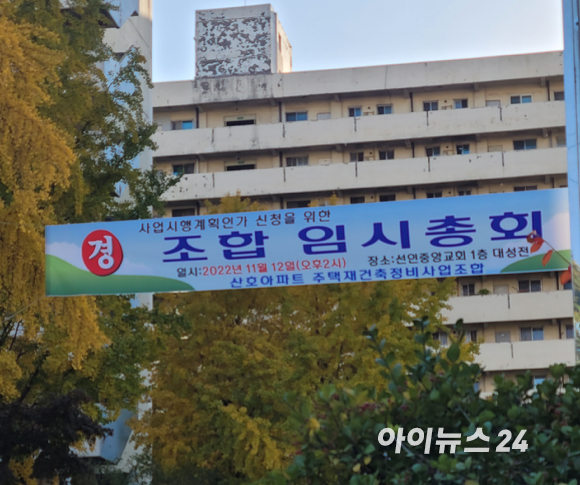 지난 12일 용산 산호아파트 정문에 '사업시행계획인가 신청을 위한 조합 임시총회'라는 제목의 현수막이 걸려 있다. 조합 관계자는 "조합원 중 104세인 분을 포함해 100세가 넘은 사람만 세 명이고 90세가 넘은 사람도 많다"며 "이들을 중심으로 사업시행계획인가에 회의적인 사람들이 있었다"고 말했다. 산호아파트는 지난 1977년 4월에 완공된 국내의 대표적인 노후 아파트 단지 중 하나다. [사진=이혜진 기자]
