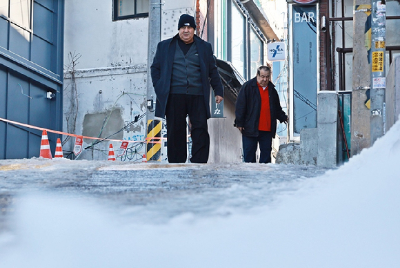 폭설 후 한파로 도로 곳곳이 얼어붙은 5일 서울 이태원역 인근에서 외국인들이 빙판길을 조심히 걷고 있다. [사진=연합뉴스]