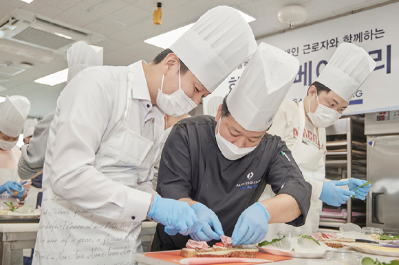 지난 17일 파리크라상 송파교육장에서 상미당홀딩스와 행복한재단이 장애인 근로자 대상 제과제빵 기술교육을 진행했다. 파리크라상 전문 강사가 장애인 제빵사에게 기술을 지도하고 있다. [사진=상미당홀딩스]