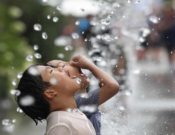서울 광화문광장 분수터널에서 어린이들이 물놀이를 즐기고 있다. [사진=뉴시스]