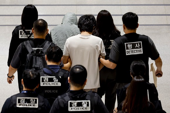 캄보디아 온라인 사기에 가담해 구금된 한국인들이 18일 오전 인천국제공항 제2터미널을 통해 송환되고 있다. 이날 송환에는 경찰 호송조 190여명이 투입됐다. [사진=연합뉴스]