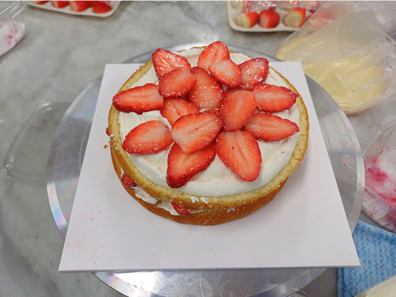 농산물유통정보(KAMIS)에 따르면 8일 기준 딸기 100g당 2435원에 판매됐다. 사진은 케이크 만들기 중 2단 시트 위에 듬뿍 올린 딸기 모습.  [사진=라창현 기자]