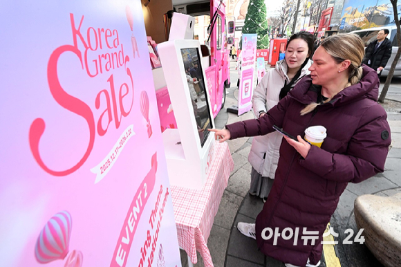 문화체육관광부와 한국방문의해위원회가 외국인의 방한 관광과 소비를 촉진하기 위한 쇼핑관광축제 '2026 코리아그랜드세일'을 내년 2월 22일까지 개최한다. 17일 서울 명동 에잇세컨즈 매장에서 외국인 관광객이 케이팝데몬헌터즈 협업 상품을 살펴보고 있다. [사진=정소희 기자]