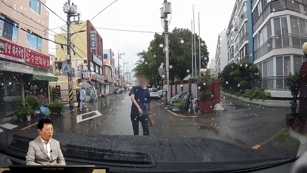 지난달 18일 오후 2시쯤 부산시 동래구에 있는 한 시장 인근 도로에서 의문의 남성이 지나가던 차량을 막고 우산을 휘두르고 있다. [영상=유튜브 '한문철TV']