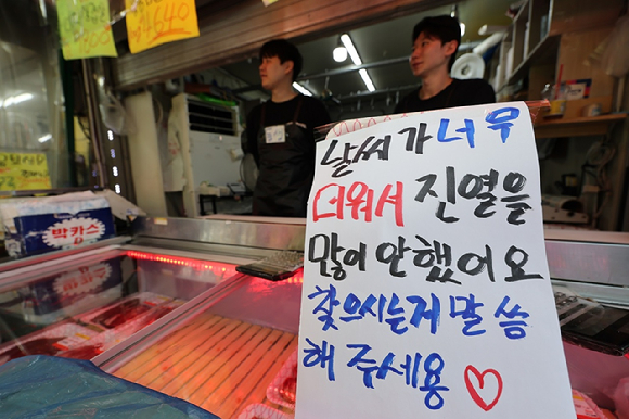 폭염 속 서울 용산구 한 정육점에 날씨가 너무 더워서 진열을 많이 안했다는 내용의 안내문이 붙어 있다. [사진=연합뉴스]