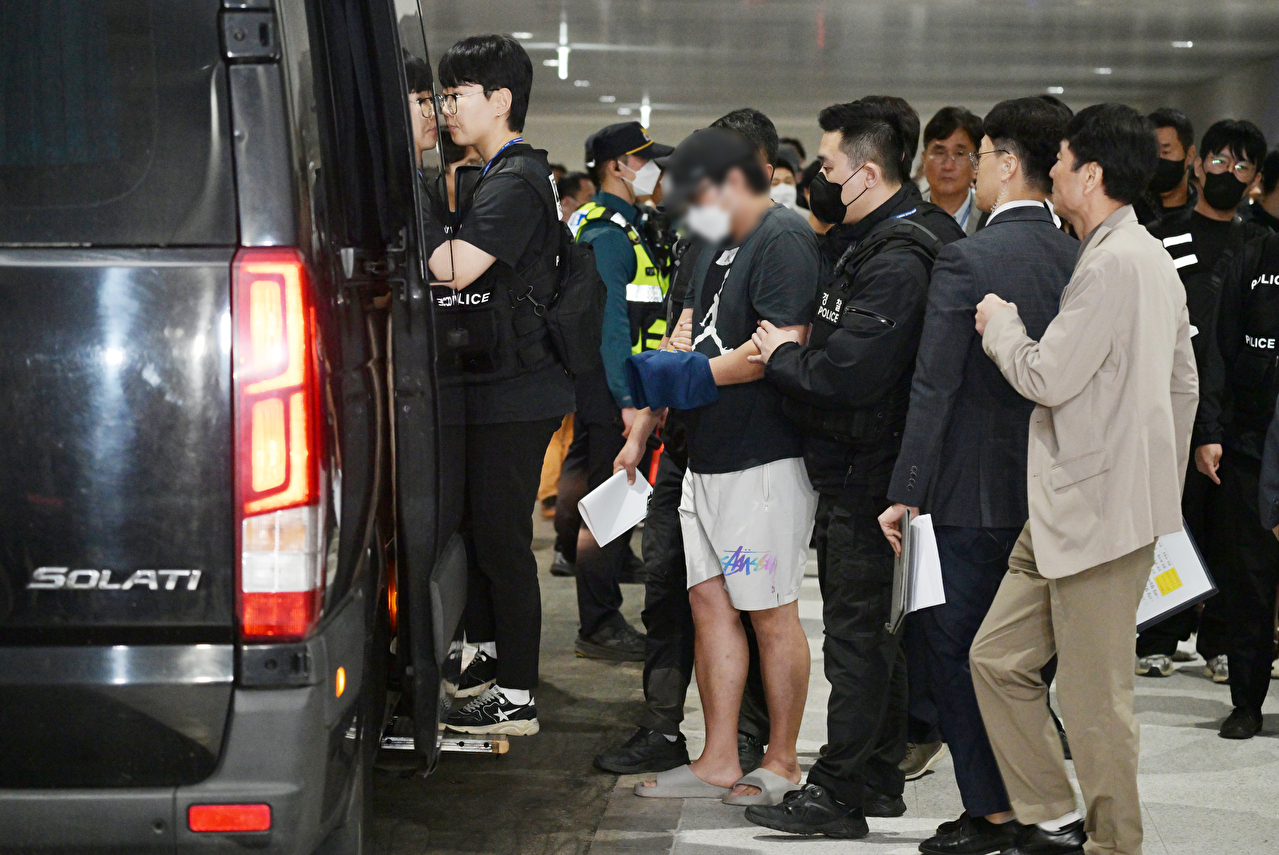 캄보디아 온라인 사기에 가담해 구금된 한국인들이 18일 오전 인천국제공항 제2터미널을 통해 송환돼 호송차에 오르고 있다. 이날 송환에는 경찰 호송조 190여명이 투입됐다. 2025.10.18 [공동취재] [사진=연합뉴스]