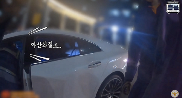 아파트단지 앞에 세워진 차량 운전석에서 아산화질소 가스통에 주입기를 연결해 흡입하던 30대 남성이 붙잡히는 장면. [사진=유튜브 채널 '경찰청']