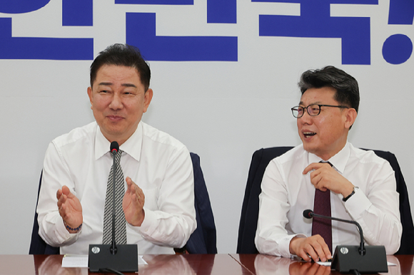 더불어민주당 김병기 당대표 직무대행 겸 원내대표(왼쪽)가 19일 서울 여의도 국회에서 열린 정책조정회의에서 진성준 정책위의장에게 손뼉 치고 있다. 2025.6.19 [사진=연합뉴스]