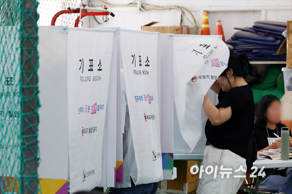 제9회 전국동시지방선거 및 국회의원 재&middot;보궐 선거가 시작된 3일 서울 중구 청구초등학교 야구부실내훈련장에 마련된 투표소에서 시민들이 투표를 하고 있다. [사진=곽영래 기자]