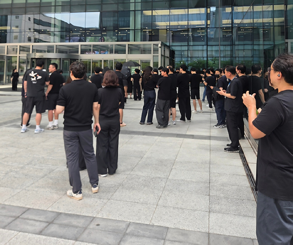 18일 경기 수원 삼성전자 사업장 앞에서 DX 부문 직원들이 검은 옷을 입고 출근 캠페인에 참여하고 있다. [사진=동행 노조]