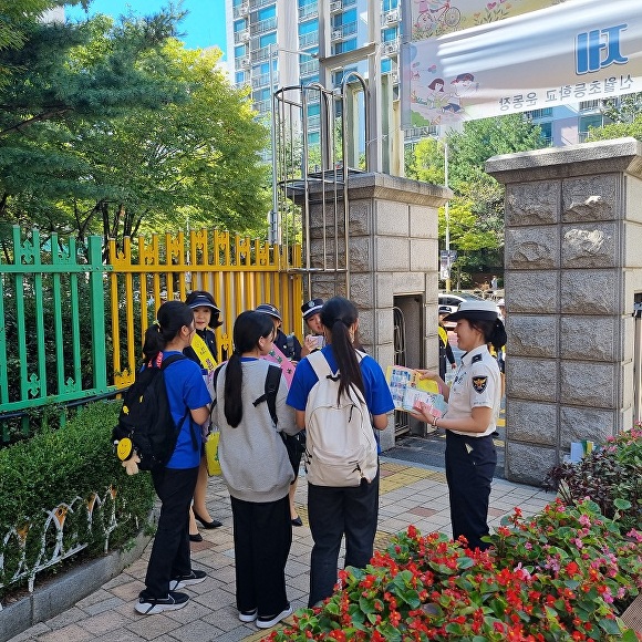 경기도남부자치경찰들이 하교하는 학생들에게 안전에 대해 홍보하고 있다. [사진=경기도]