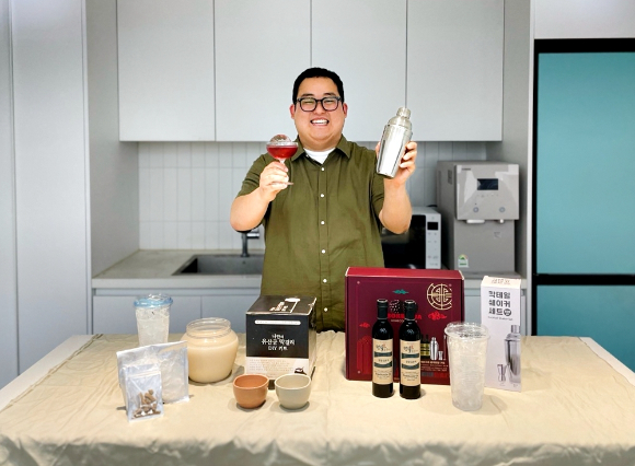 모델이 편의점 CU가 새롭게 출시하는 DIY(Do It Yourself) 전통주 상품을 소개하고 있다. [사진=BGF리테일]