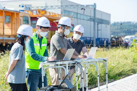 ﻿SK텔레콤 직원들이 '5G 차상통신장치'에 5G 에지 클라우드와 5G 품질 최적화 기술을 적용, 저지연 통신 테스트를 진행하고 있는 모습.[사진=SKT]