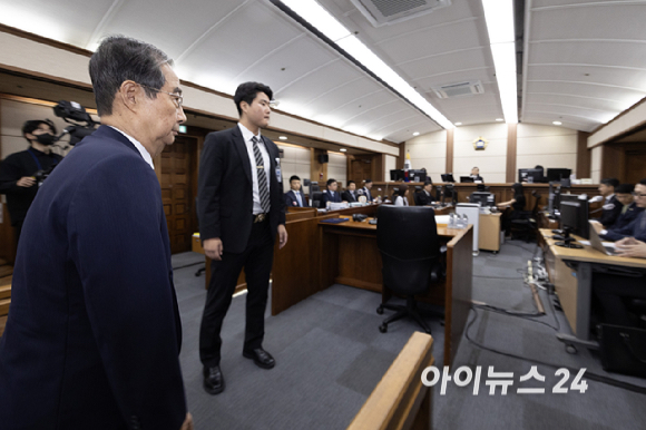 '내란방조 혐의'로 특검에 기소된 한덕수 전 국무총리가 30일 오전 서울 서초동 중앙지법에서 열린 첫 재판에 출석하고 있다. [사진=사진공동취재단]