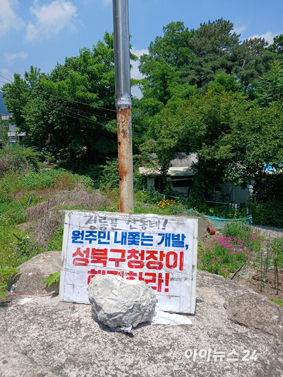 서울 성북구 정릉골 재개발 구역 일대에 강제집행 중단과 세입자 대책 마련을 요구하는 팻말이 설치돼 있다. [사진=김민지 기자]