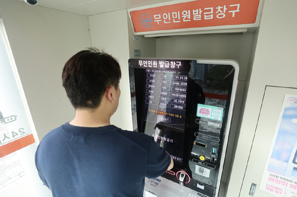 정부가 지난달 26일 국가정보자원관리원(국정자원) 화재로 마비된 행정서비스 복구작업에 나선 가운데 지난 1일 서울 한 구청 무인민원발급창구에서 한 시민이 발급기를 이용하고 있다. [사진=연합뉴스]