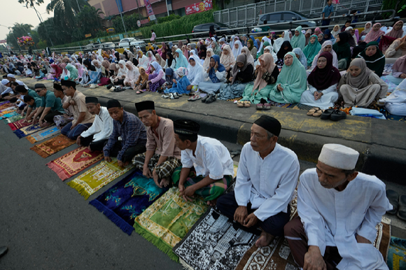 지난 17일(현지시각) 인도네시아 자카르타의 한 거리에서 무슬림들이 이드 알 아드하 기도회에 참석하고 있다. [사진=뉴시스 ]