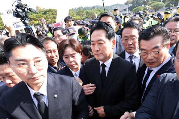 6일 오후 광주 북구 국립5·18민주묘지에서 국민의힘 장동혁 대표가 인파에 둘러싸인 채 추모탑으로 이동하고 있다. [사진=연합뉴스]