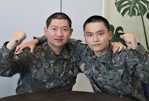 용인 처인구의 한 식당에서 20대 여성의 생명을 구한 (왼쪽부터) 김태현 일병, 김현재 일병이 주먹을 쥐고 있다. [사진=지상군작전사령부]