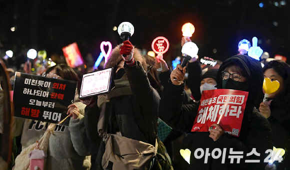 지난 2024년 12월 13일 서울 영등포구 산업은행 본점 앞에서 열린 '내란수괴 윤석열 즉각 탄핵! 즉각 체포! 탄핵촛불문화제' 에서 시민들이 응원봉을 흔들며 구호를 외치고 있다. [사진=곽영래 기자]