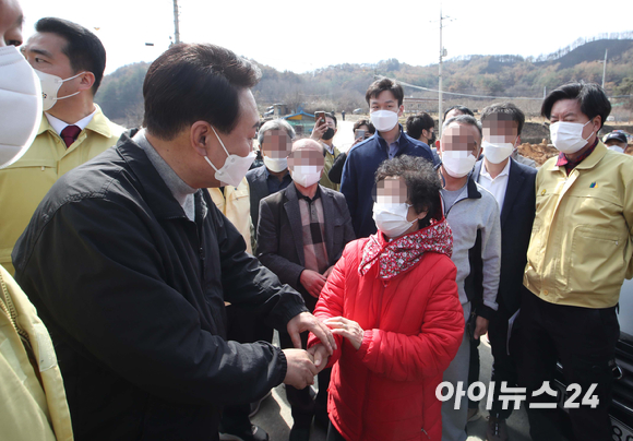 윤석열 대통령 당선인이 15일 경북 울진군 북면 검성리 산불피해현장을 방문해 피해지역 주민들과 인사하고 있다. [사진=국회사진취재단]