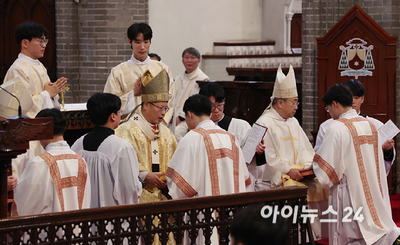 1일 서울 중구 명동대성당에서 열린 2024년 천주교 서울대교구 부제 서품식에서 정순택 대주교를 비롯한 교구 주교·사제단이 부제 수품자들에게 복음집을 수여하고 있다. [사진= 사진공동취재단]